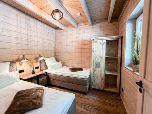 a room with two beds and a desk in a room at Hercynia Lodge in Bad Lauterberg