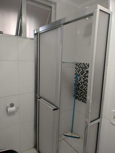a shower with a glass door in a bathroom at AP 50 Metros do Mar in Mongaguá