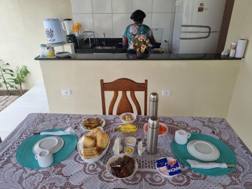 a table with plates of food on it in a kitchen at Pousada Peromar in Maragogi