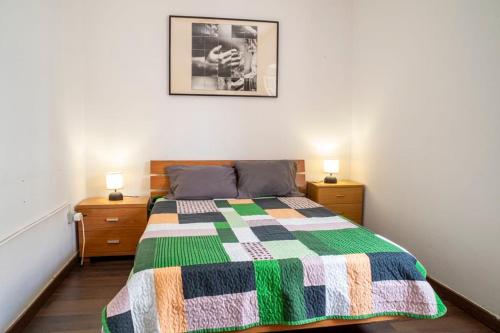 a bedroom with a bed with a colorful quilt on it at Front House in Lisbon