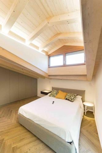 a bedroom with a large white bed in a room at Nuova Luxury Suite Chaligne in Aosta