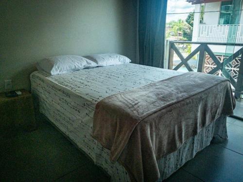 a bed sitting in a bedroom with a window at Refúgio da Prainha in Taperoá