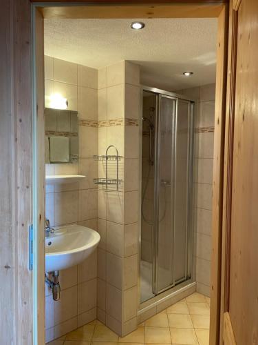 a bathroom with a sink and a shower at Neuhauserhof in Kartitsch