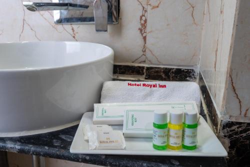 a bathroom with a sink and a tray with bottles of soap at Hotel Royal Inn igi in New Delhi