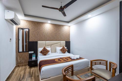 a hotel room with a bed and a table and chairs at Hotel Royal Inn igi in New Delhi