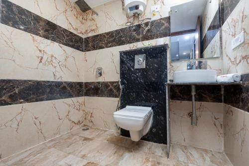 a bathroom with a toilet and a sink at Hotel Royal Inn igi in New Delhi