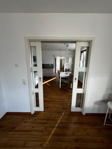 a room with a door open to a living room at LandschaftsTräume in Simmerath