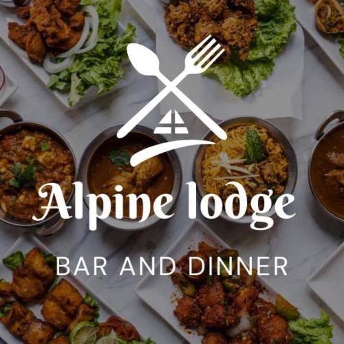 a table topped with different types of food with a sign at Alpine Lodge Bansko Apartments in Bansko