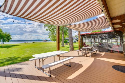 two benches on a deck with a view of a park at Lakefront Graford Home with Fire Pit and Private Dock! in Graford