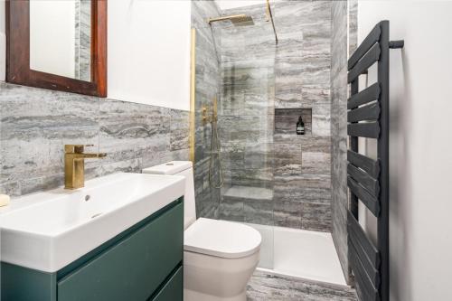 a bathroom with a sink and a toilet and a shower at Parade Gardens Boutique Apartments- Central, Grade I Listed, 4K TVs, Hidden Views in Bath