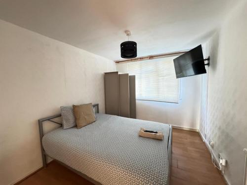a small bedroom with a bed and a window at PRP Pennack Road Peckham London in London