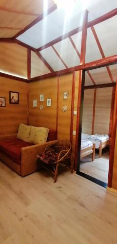 a room with a couch and a bed in it at Kucerak na Drini in Bajina Bašta