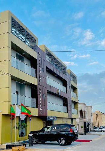a black car parked in front of a building at Milennium Hotel Nouadhibou in Nouadhibou