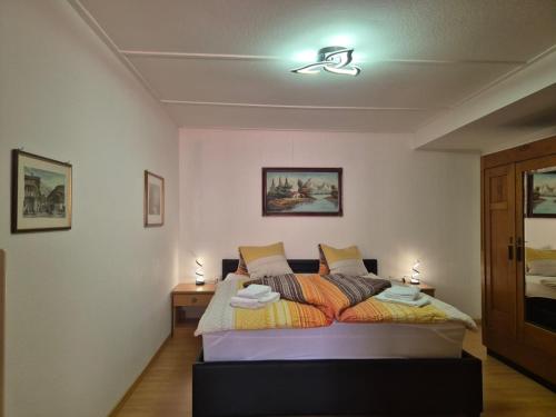 a bedroom with a bed with two lights on the ceiling at Chalet Aargovia South in Wengen
