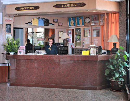 a person sitting at a counter in a restaurant at Hotel Rainbow in Cameron Highlands
