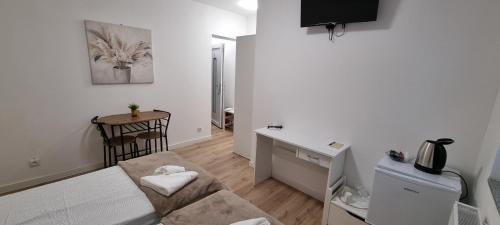 a living room with a couch and a desk at Infinity app 2024 in Beli Manastir