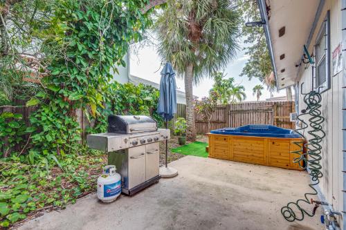 a backyard with an outdoor stove and a pool at Cape Canaveral Cottage with Hot Tub Walk to Beach in Cape Canaveral