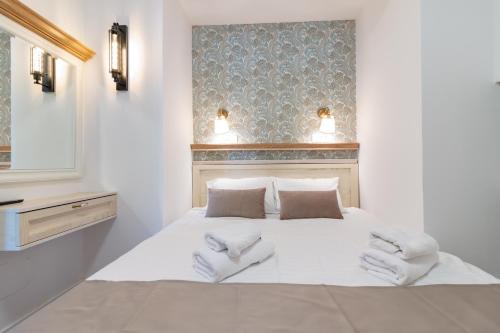 a bedroom with a white bed with towels on it at Villa Elena - Dolni Saraj in Ohrid