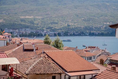 a view of a town with roofs and a body of water at Villa Elena - Dolni Saraj in Ohrid