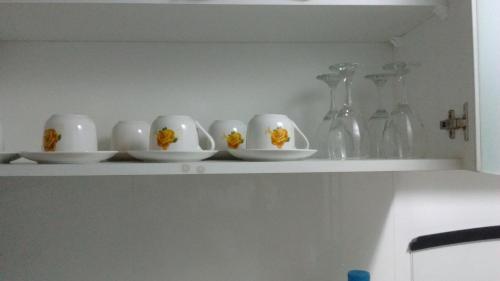 a row of white cups sitting on a shelf at Apartamento en Centro Historico de Lima in Lima