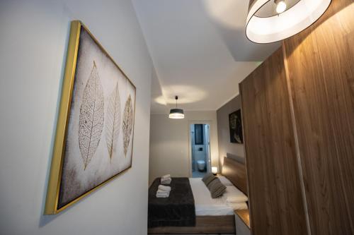 a room with a bed and a picture on the wall at 2-bed apartment in Mellieha with sea and country view in Mellieħa