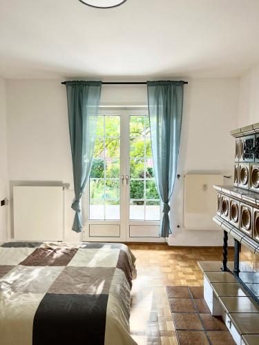 a bedroom with a bed and a large window at City House Neuss in Neuss