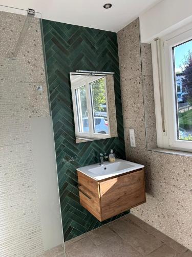 a bathroom with a sink and a mirror at Panoramaapartment Wine & Castle in Bernkastel-Kues