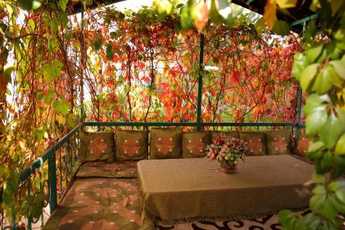a balcony with a table and flowers on it at Alpinist Hotel in Bishkek