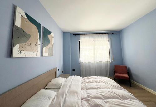 a bedroom with a white bed and a window at B2 Apartment in Tirana