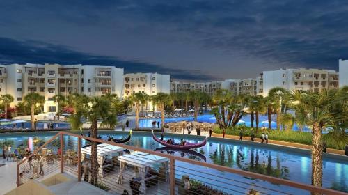 a view of a resort with palm trees and buildings at Outstanding Flat with pool and near the beach in Sahline
