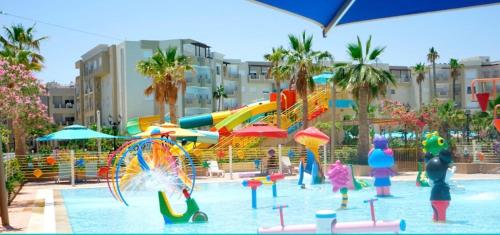 a pool with a water park with a water slide at Outstanding Flat with pool and near the beach in Sahline