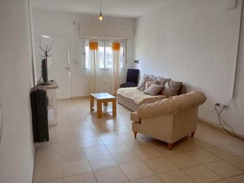 a living room with a couch and a table at Complejo DelfIn Gallo in Santa Rosa