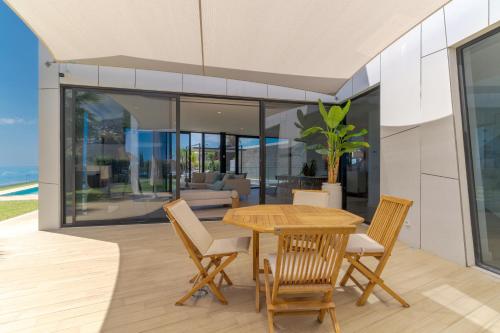 a dining room with a table and chairs at Luxury Diamond House by Holiday Rental Madeira in Funchal