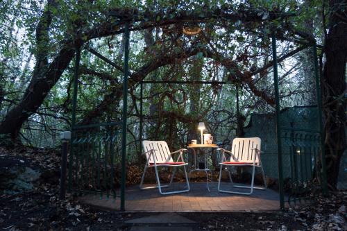 a gazebo with two chairs and a table in it at I Marchesi dell'Etna in Zafferana Etnea