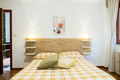 a bedroom with a bed with two pillows at I Marchesi dell'Etna in Zafferana Etnea