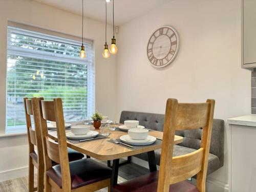 a dining room with a wooden table and chairs at Modern 3 Bedroom Home - Free Driveway Parking - 6 Guests - Upstairs Bathroom and Downstairs WC in Armthorpe