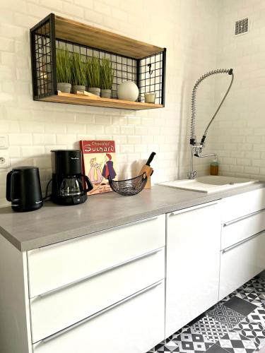 a kitchen with a counter top with a sink at Charmante maison à 20min de Lille in Oignies