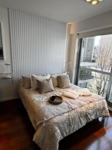 a large bed in a bedroom with a large window at Modern Studio in Palermo Hollywood in Buenos Aires