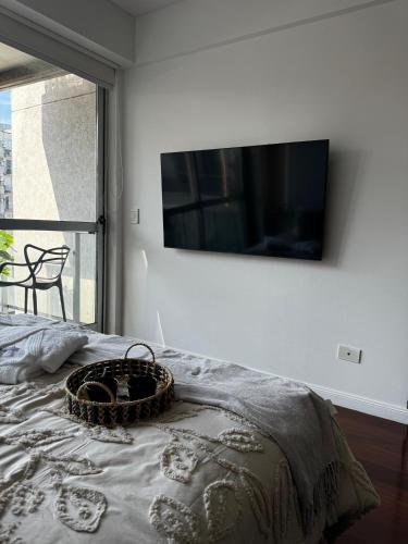 a bedroom with a bed with a television on the wall at Modern Studio in Palermo Hollywood in Buenos Aires