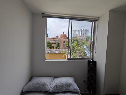 a bedroom with a window with a bed and a speaker at Apartamento Portal 18 in San Alonso