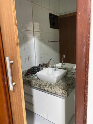 a bathroom with a white sink and a mirror at Casa da Barra99 in Francês