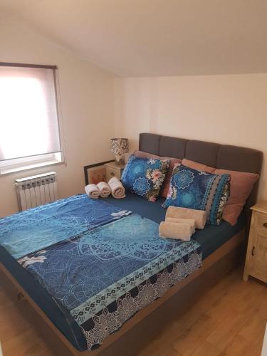 a bedroom with a large bed with blue sheets and pillows at Villa Iva in Medulin