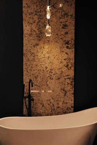 a bath tub with a chandelier above it in a bathroom at The Vault Luxury Apartment in Berwick-Upon-Tweed