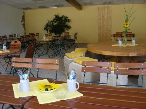 a restaurant with two tables and chairs and tables and tablesktop at Landgasthof Zum Wolfsberg in Dietfurt