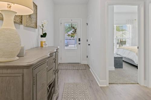 a bedroom with a bed and a table with a vase at Fully-Fenced Backyard l Perfect for Families and Groups in Saint Peter