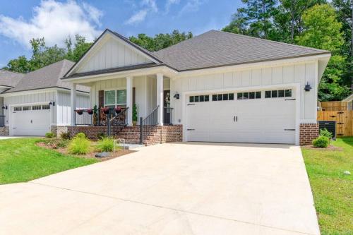 a house with white garage doors at Fully-Fenced Backyard l Perfect for Families and Groups in Saint Peter