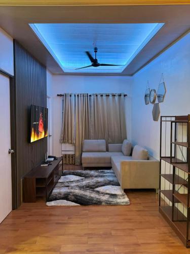 a living room with a couch and a ceiling at 3BR Davao Condo 7thfloor near Airport in Pagamikan