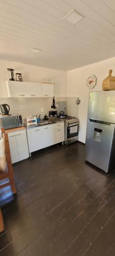 a kitchen with a stainless steel refrigerator in a room at La cabaña 2 dormitorios in Ocean Park