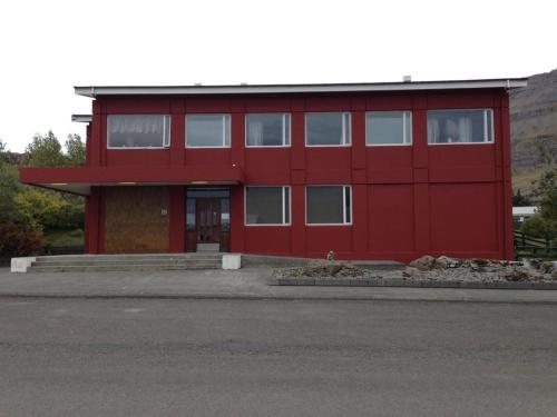 a red building with a red at Hotel Post in Breiðdalsvík
