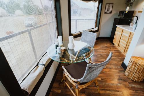 a glass table and chairs in a room with a window at Starlight Haven at Weiss Lake in Gaylesville